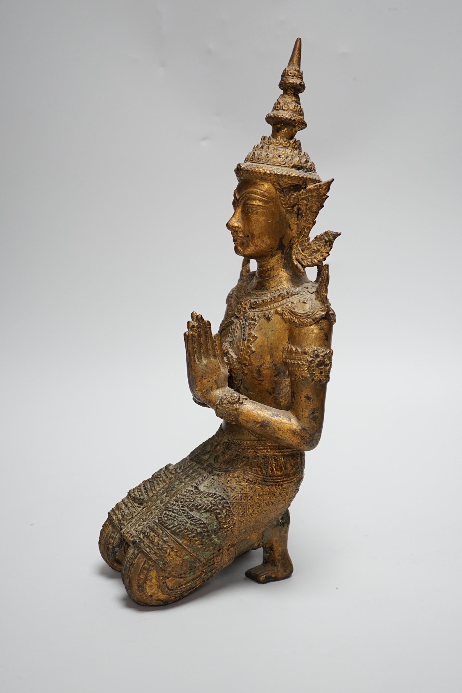 A Thai kneeling Buddha in gilt bronze, 34cm